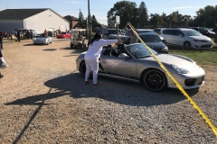 SEM Community Chair Chrissy greeting the incoming cars